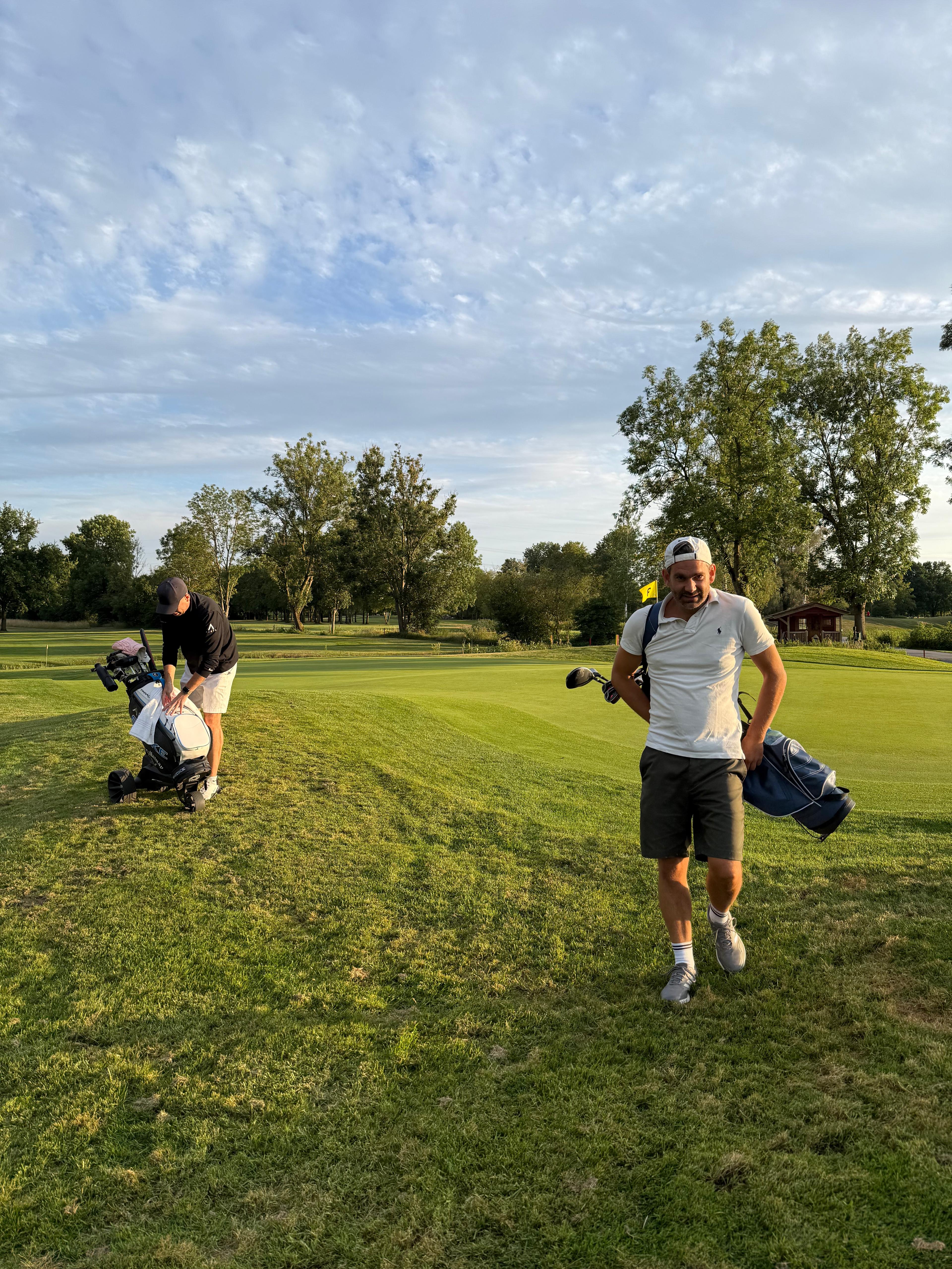 Golfer mit ihren Bags im Abendlicht